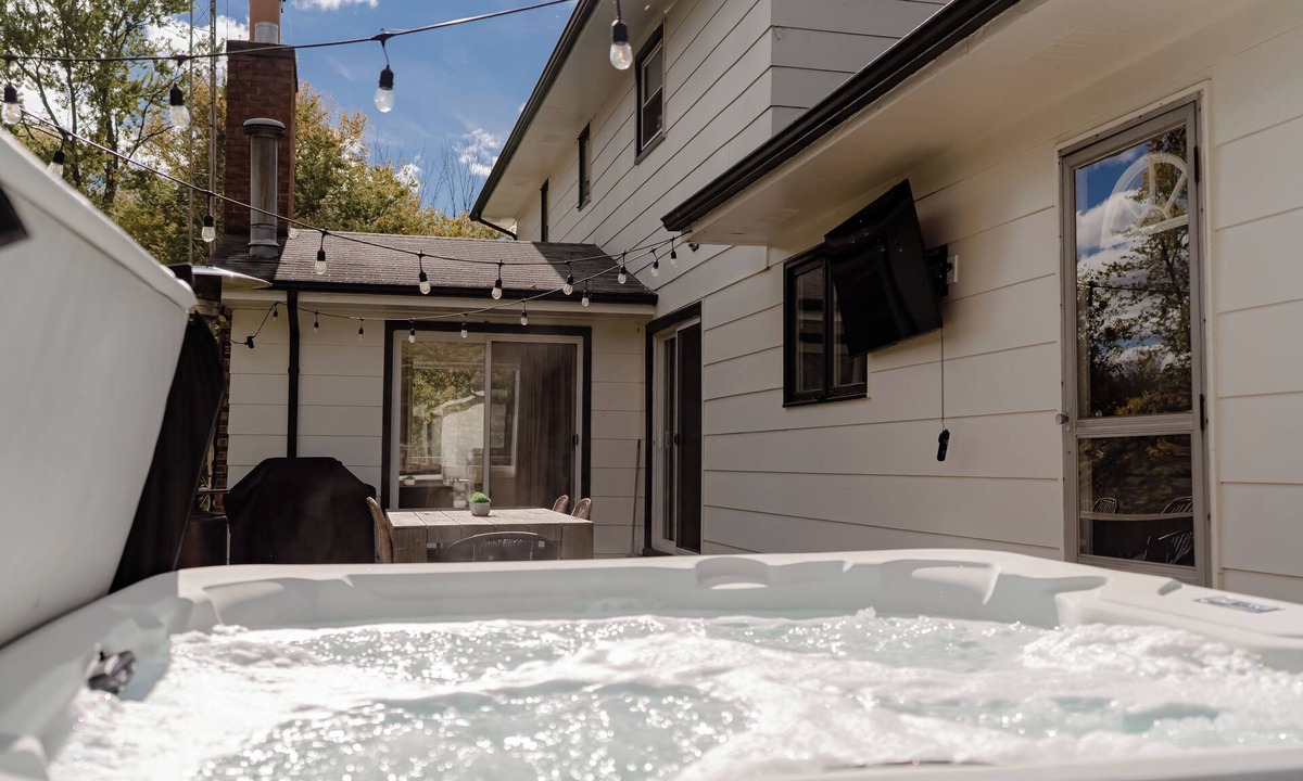 Riverside House | Evergreen Lodge - Enjoy relaxing in the hot tub or smores by the fire!