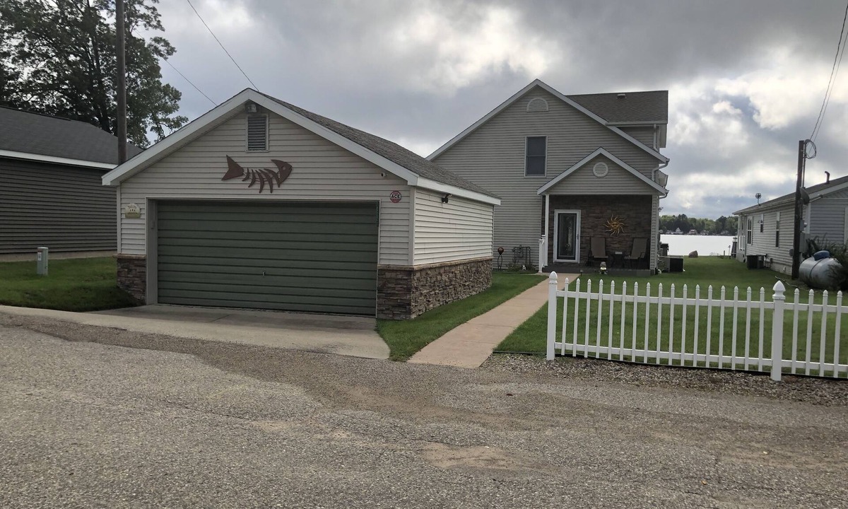 Lake House | Relax at the outdoor firepit or hot tub overlooking all-sports Eight Point Lake!