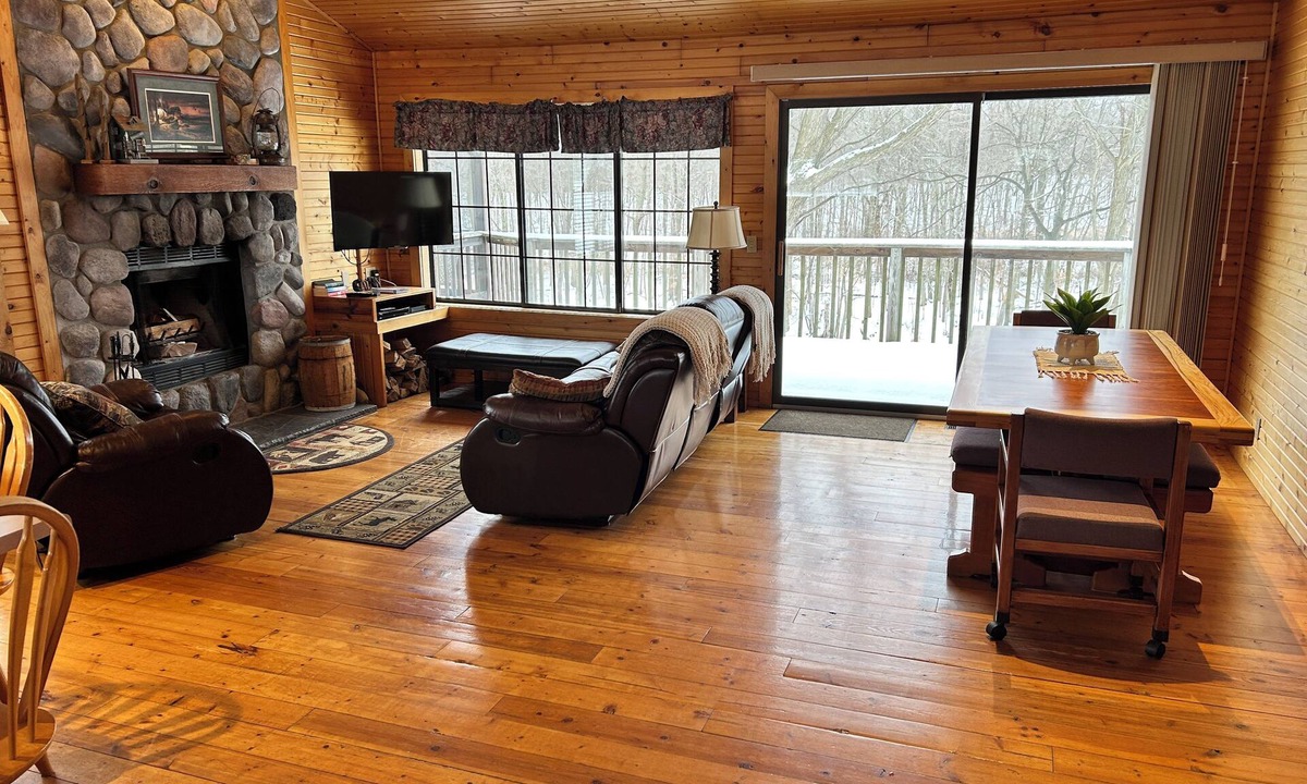 South Haven Cottage | Riverbend Retreat Middle Branch Cottage Fireplace and hot tub with river view.