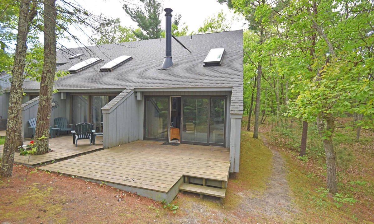 Glen Arbor Condo | Riverfront condo with water views, deck, fireplace, W/D, and community firepit