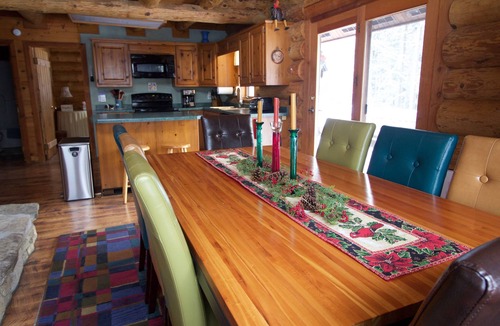 Egg Harbor House | Beautiful log home with wrap-around deck surrounded by trees.