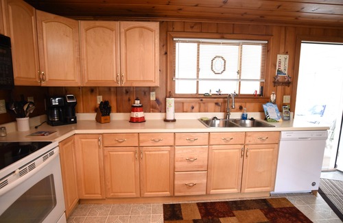 Prudenville Cottage | Centrally located, four season retreat w/firepit and lakeview.