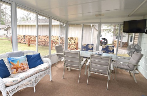 Prudenville Cottage | Centrally located, four season retreat w/firepit and lakeview.