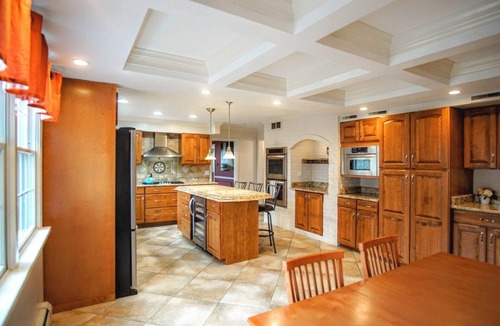 Stevensville House | Colonial style 5BR/5BA home tucked in a private, wooded setting w/pool & hot tub
