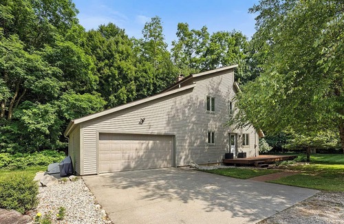 Ada House | Escape to a 4BR/2Bath wooded retreat just minutes from Grand Rapids.