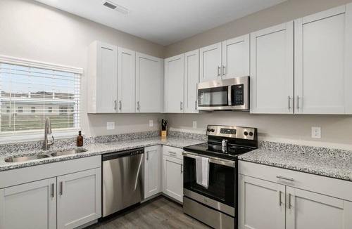 Grandville Apartment | Modern 4BR 4BA Two Unit Condo w Garage and Patio