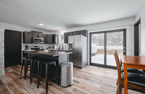 Grawn House | Pet-friendly home with fenced-in yard and hot tub