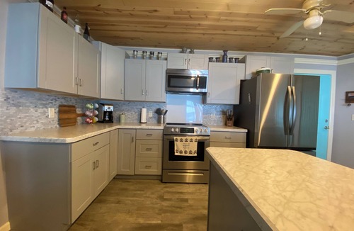 Little Sturgeon House | Prime sunsets, great kayaking, huge yard, volleyball court, and free firewood