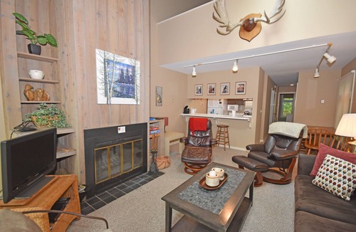 Glen Arbor Condo | Riverfront condo with water views, deck, fireplace, W/D, and community firepit