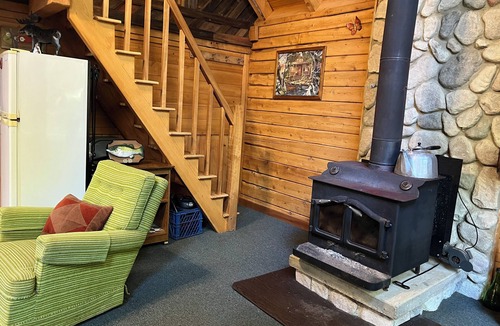 Crystal Falls Cabin | Rustic Forest Getaway has the comforts of home surrounded by woods and water.