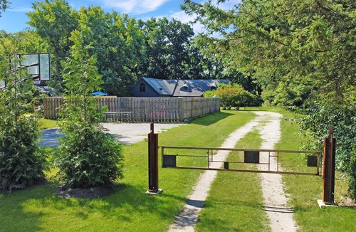 Fair Plain House | Spacious group getaway with heated pool, sauna, basketball court, and firepit. Sleeps up to 15 guests and is just minutes from Lake Michigan beaches and downtown St. Joseph. Perfect for family vacations, group trips, and relaxing Southwest Michigan.