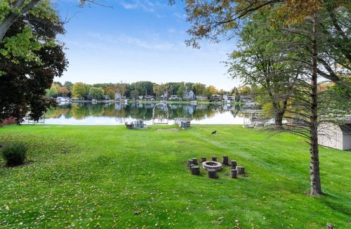 Powers Lake House | The Lake House on Powers |Grassy Frontage |Lakeside Deck |Rec Room w/Pool Table & Bar |Fire Pit