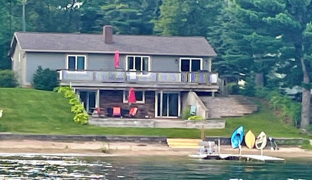 Charming 3-bedroom lake front property on Middle Lake. Private beach and dock.