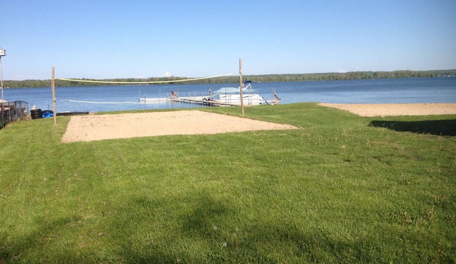 Gun Lake Vacation Rental, Sandy beach, docks, picnic tables, kids play grounds