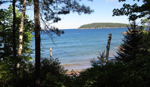 Quiet, isolated oasis on 300 feet of Lake Superior beach and 10 wooded acres.
