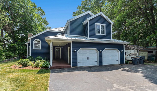 Serene lakefront retreat with an expansive deck, dock access, game room, & AC