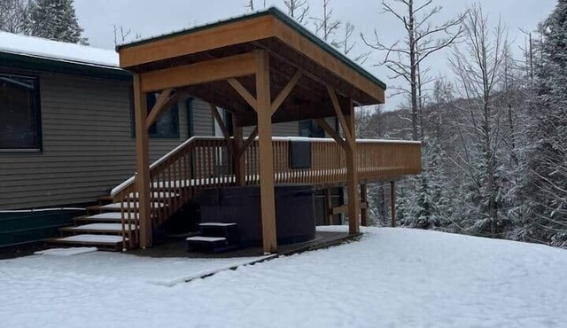 Ski getaway with hill view and hot tub- Upper Unit